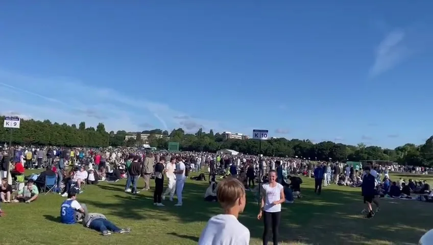 Thousands of people gathered on the grass at a large outdoor festival we catered