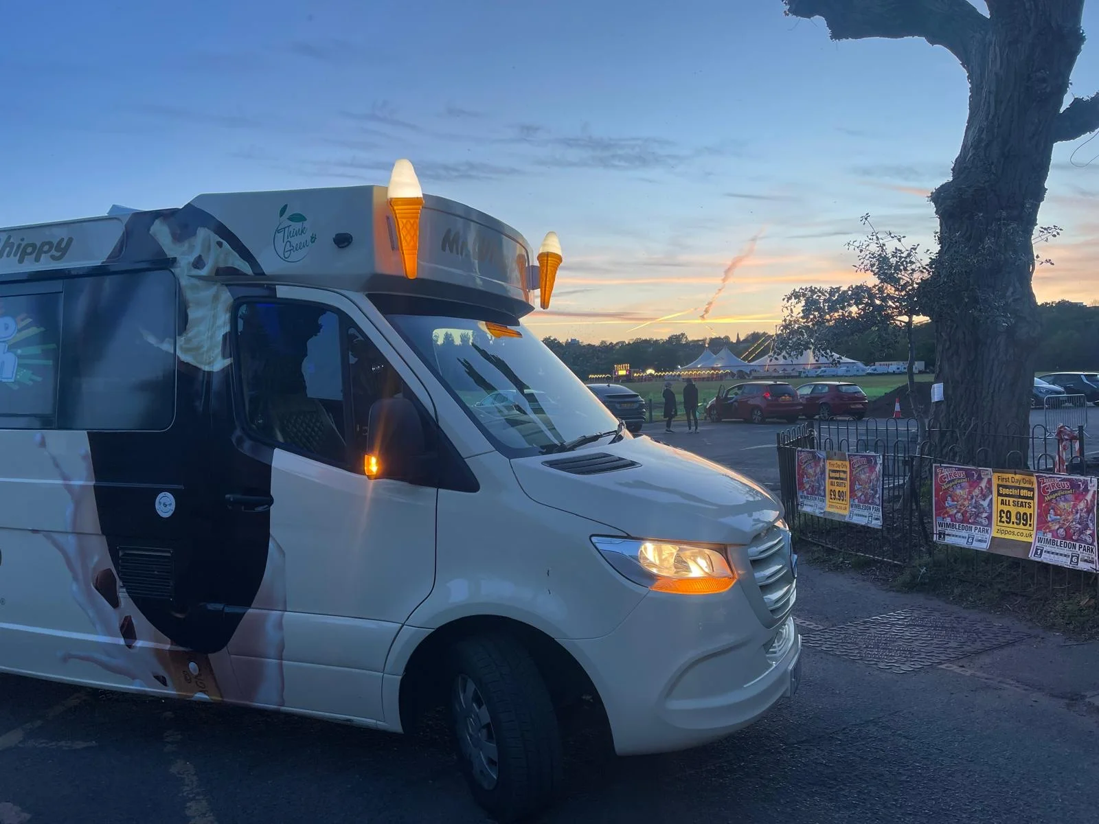 The Kreamy Delights van at dusk beside a funfair