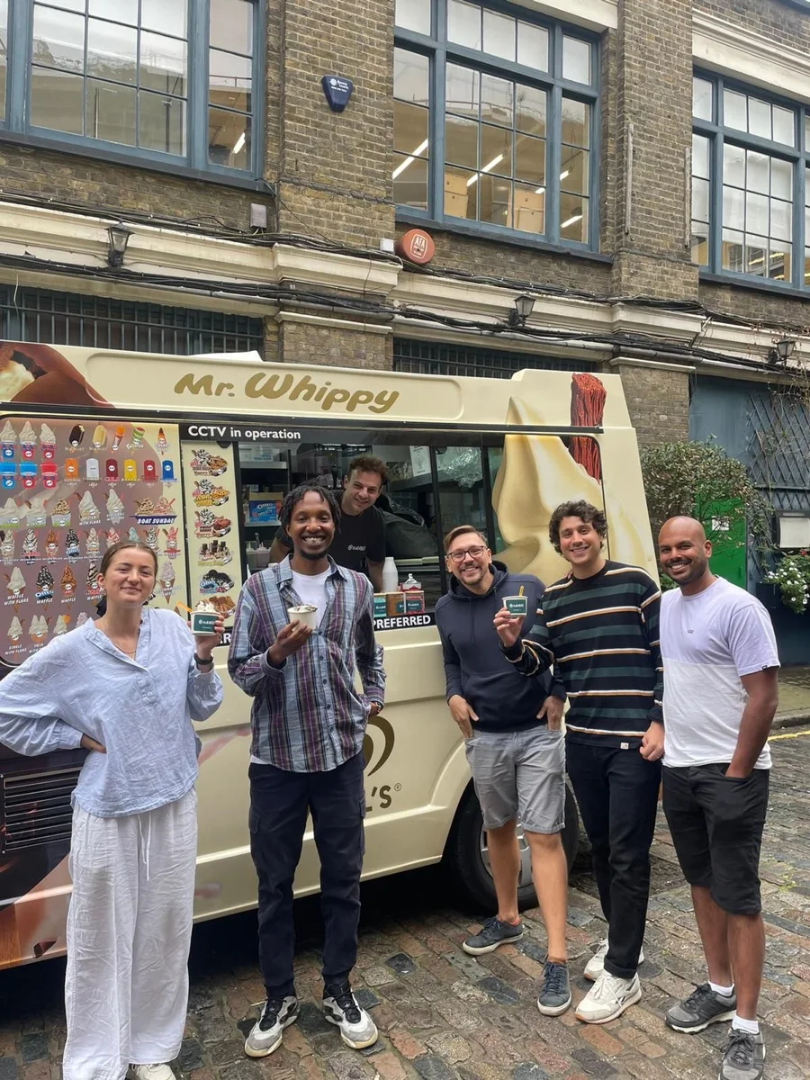 Guests holding ice creams beside the Kreamy Delights van on a London street
